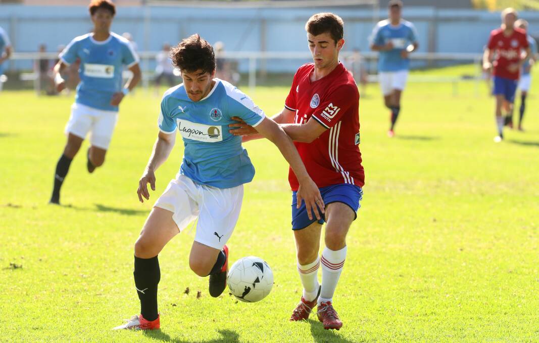 UP FOR GRABS: Olympic's Julian Minutillo battles for possession against Albion Park White Eagles earlier this season. Picture: Sylvia Liber. 
