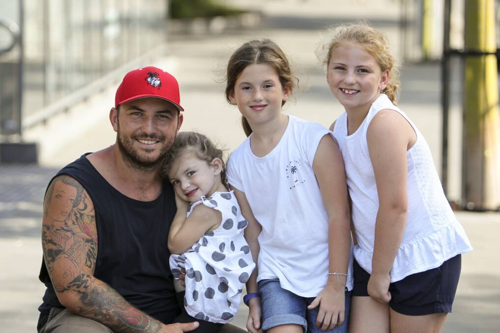 GRATEFUL: East Corrimal dad Trent Lloyd with daughter Edie, 3, and Ruby, 9, and their cousin Charlotte Payne, 7 (middle). Picture: Anna Warr.