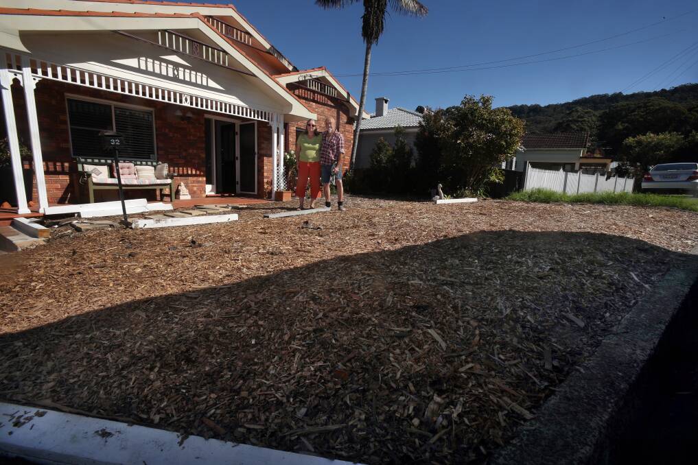 BEAUTIFICATION: Fiona Chanter and Andrew Saunders outside their Woonona home where council has warned they may face a fine for the verge garden - seen here covered in mulch. Picture: Robert Peet. 