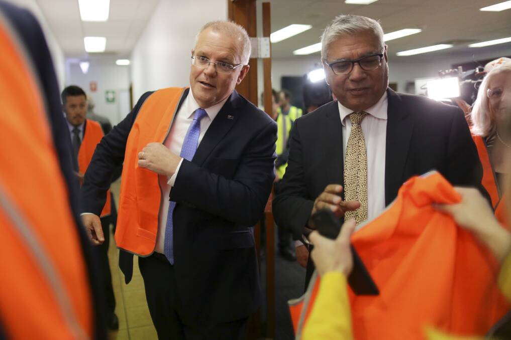 If the shirt fits: Scott Morrison and Warren Mundine get their campaign high-vis on in Nowra last week.