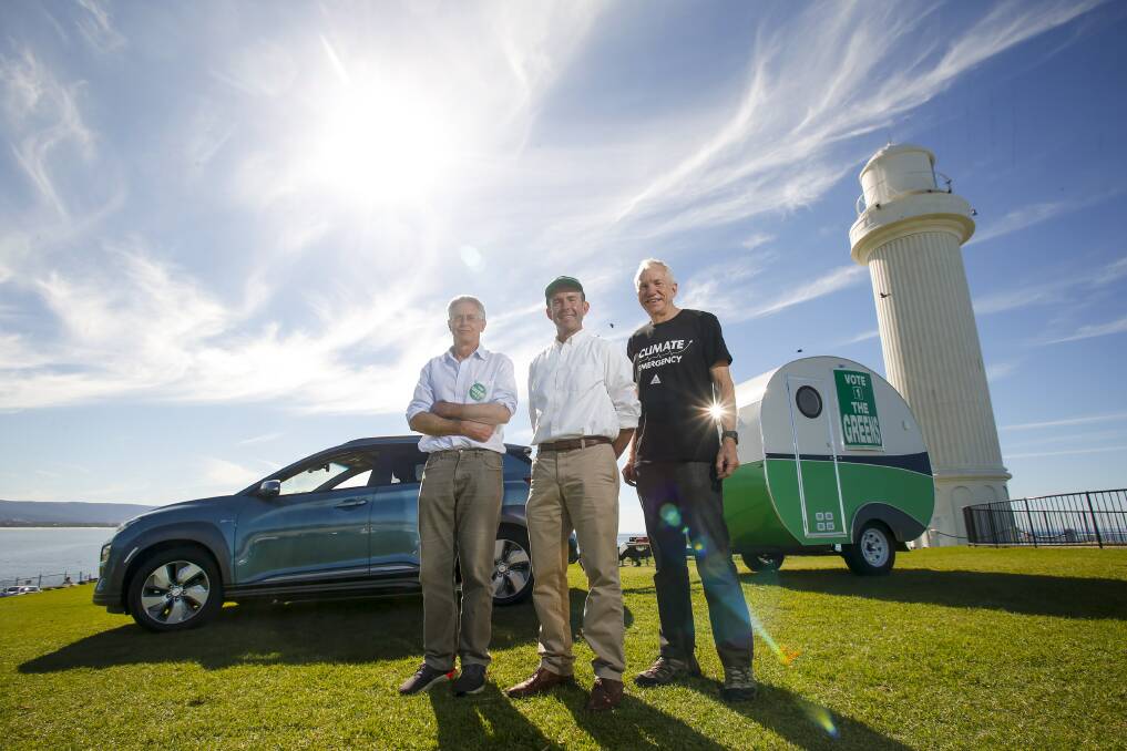GREEN POWER: Rowan Huxtable and Jamie Dixon with electric car enthusiast Tom Hunt and the campaign caravan. Picture: Anna Warr.