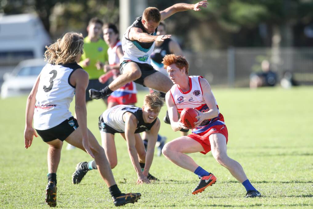 Evasive action: Bulldogs' player Mathew Pilbrow tries to avoid Kiama rivals during Saturday's game at Bonaira Oval. Picture: Adam McLean