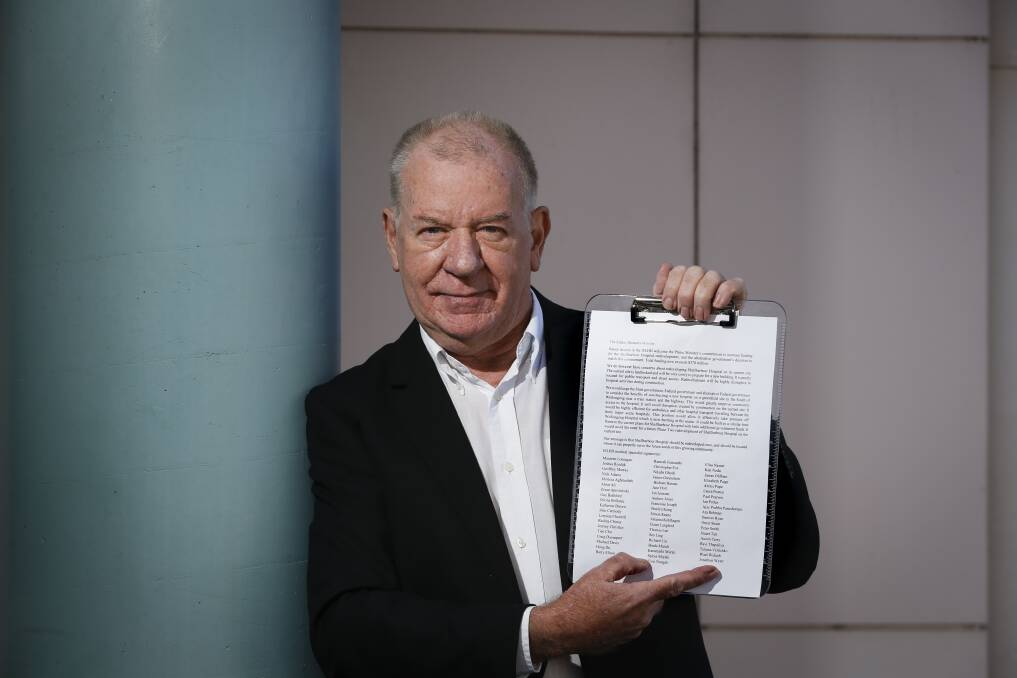 Push for change: Dr Geoffrey Murray with the letter signed by almost 60 of his fellow doctors which calls for Shellharbour Hospital to be rebuilt on a new site rather than redeveloped at its current location in Mount Warrigal. Picture: Anna Warr