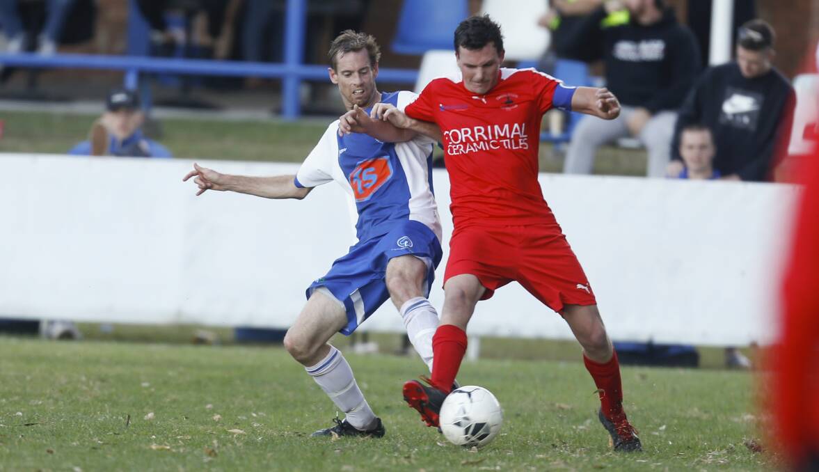 Clash: Tarrawanna's Benjamin Spruce and Corrimal player Tim Wylie during the Blueys' 2-nil win earlier this year. Picture: Anna Warr