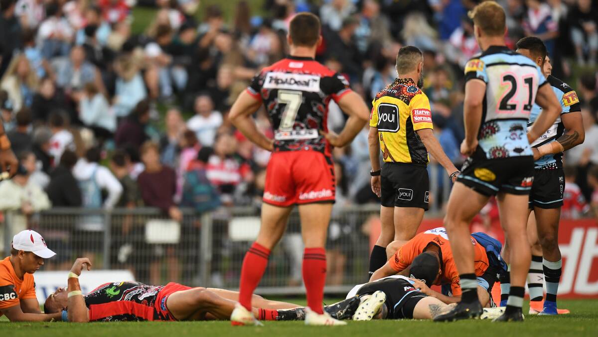 Injury scare: Tyson Frizell (left) and Josh Dugan receive treatment after their head clash on Sunday afternoon. Picture: AAP Image/Dean Lewins.