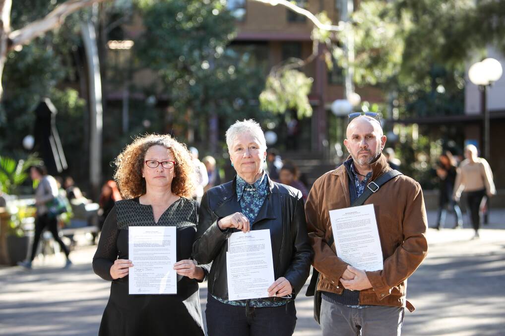PENNING FRUSTRATIONS: UOW academic staff Dr Jane Carey, Associate Professor Georgine Clarsen and Dr Marcelo Svirsky with a copy of the letter given to university management about their Ramsay Centre deal concerns . Picture: Adam McLean