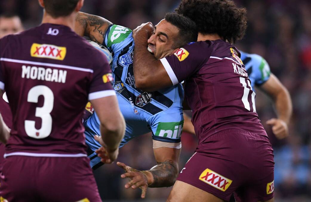 Crunch time Paul Vaughan is tackled in the Blues loss to Queensland at Suncorp Stadium. Picture: AAP Image/Dan Peled