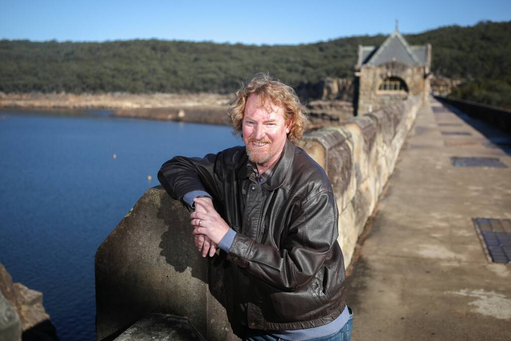 James Stewart Keene at the wall of Cataract Dam. He is working on a feature film about his great, great grandmother Evangeline Keene who lived in the village of Sherbrooke that the NSW government claimed and flooded in the construction of the dam. Picture: Adam McLean