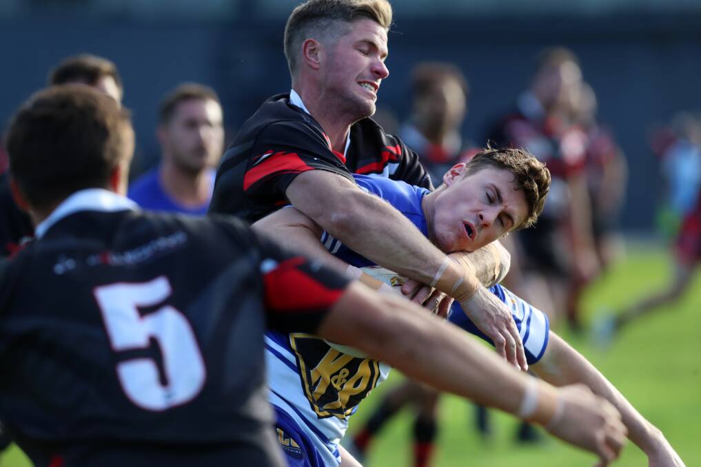 KEY MEN: Collegians' Jarrod Boyle and Thirroul's Jake Walsh clash in Saturday's thriller. Picture: Sylvia Liber