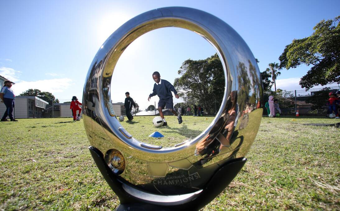 Future star: Wollongong Public School students were excited to touch the A-League and W-League trophies on Tuesday. Picture: Adam McLean.
