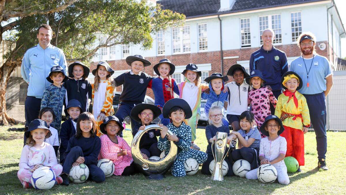 All smiles: Wollongong Public School students with the A-League and W-League trophies during a visit by Sydney FC. Picture: Adam McLean.