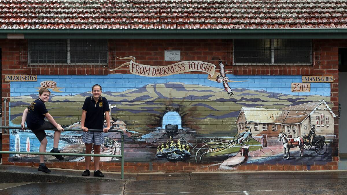 CELEBRATIONS: Bulli Public School captains Jacob Simonsen and Indy Davidsohn Grose with a section of the new mural at the school. Picture: Robert Peet