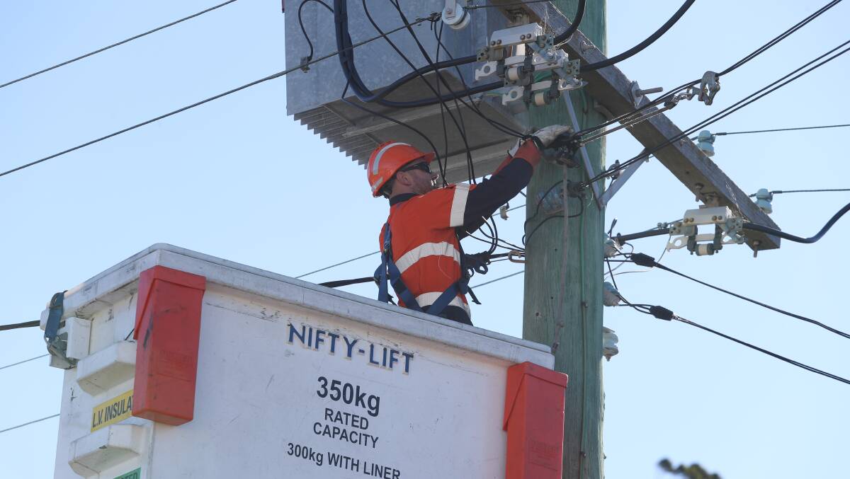An Endeavour Energy crew member working to repair damaged power lines in Campbell Street, Woonona on July 13, 2019. Picture: Robert Peet