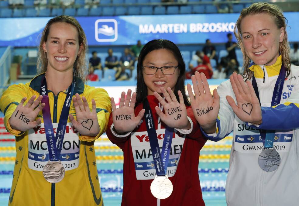 Support: Gold medalist Canada's Margaret MacNeil, centre, gestures with silver medalist Sweden's Sarah Sjostrom, right, and bronze medalist Australia's Emma McKeon to Japanese swimmer Rikako Ikee. Picture: AP Photo/Lee Jin-man