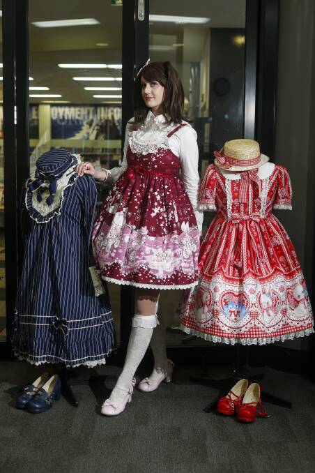 Brit Alcock and some of her dresses on display at a Lolita fashion workshop at Wollongong Library on Saturday. Picture: Anna Warr