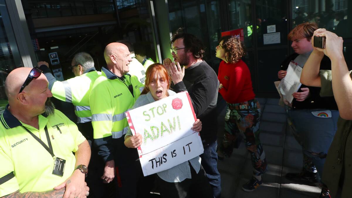 DEMANDING ACTION: Anti Adani protesters outside UOW"s Innovation Campus during the visit of Education Minister Dan Tehan. Picture: Sylvia Liber