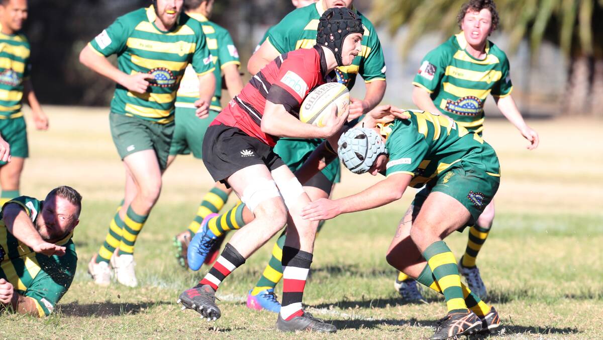 On the front foot: Tech forwards Tom Ciot attempts to bump off a defender in Saturday's victory over Shoalhaven. Picture: Sylvia Liber.