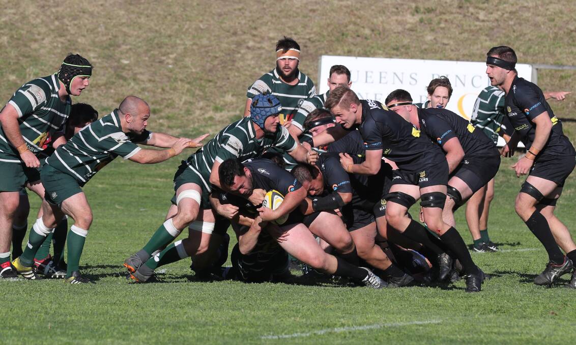 Physical encounter: Bowral's Todd Pearce is tackled. Picture: Robert Peet.