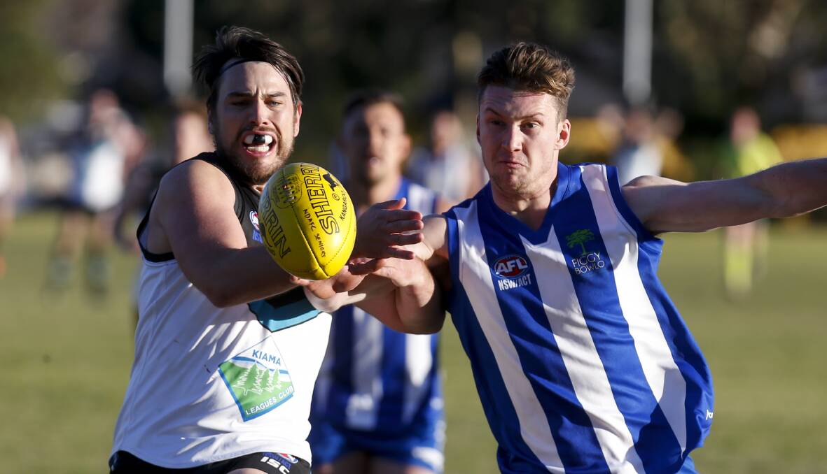 Battle: Kiama's Bryce Koop and Figtree rival Adam Schuback scramble for possession in Saturday preliminary final at Hollymount Oval. Picture: Anna Warr