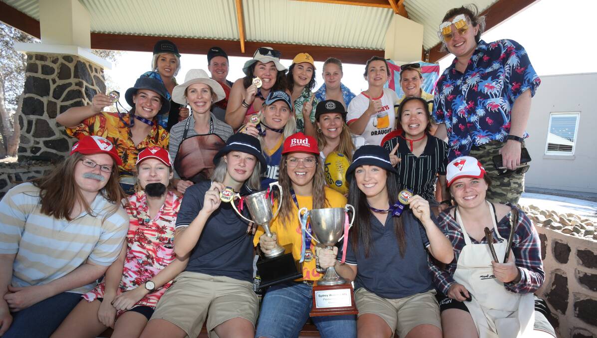 Celebration: The Wollongong Saints at a team barbecue at Stuart Park on Sunday, after winning the AFL Sydney division one premiership. Picture: Robert Peet