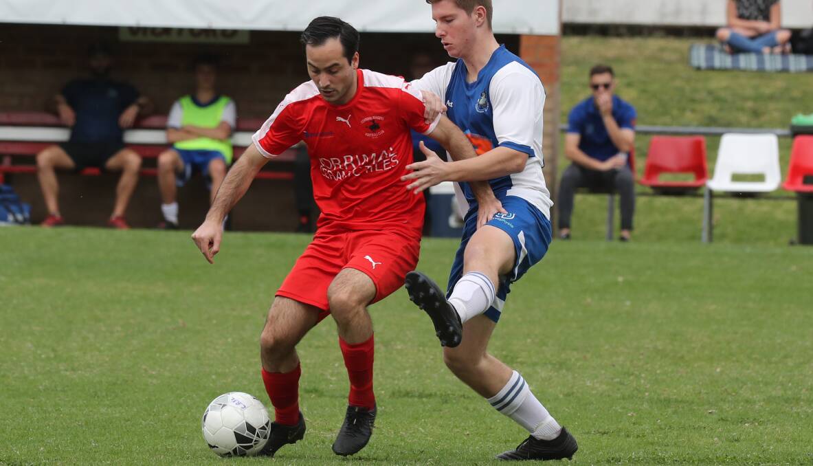 Fighting through: Corrimal's Lukas Stergiou battles past Benjamin Learmonth on Sunday afternoon. Picture: Robert Peet.
