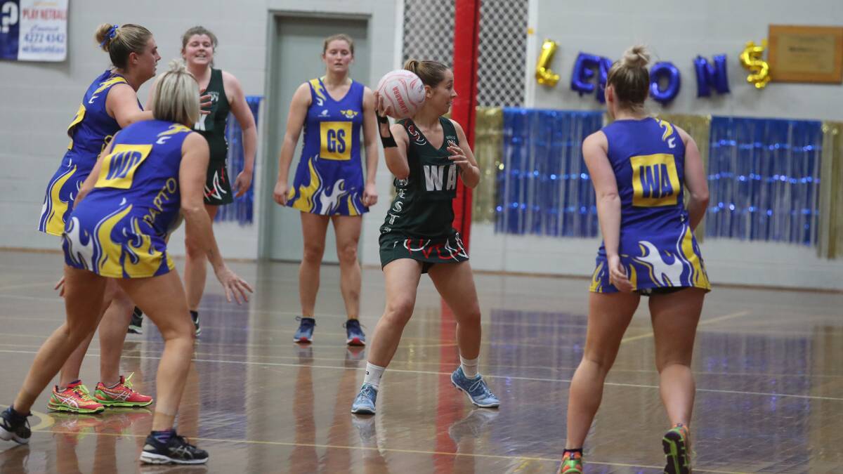 Surrounded: Wests' Jessica Osborne searches for a teammate in Saturday's grand final win over Dapto. Picture: Robert Peet.