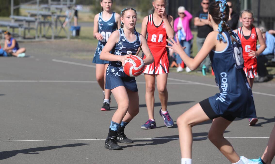 Linking up: Corrimal's Skye Spencer looks for a teammate during Saturday's grand final victory. Picture: Robert Peet.