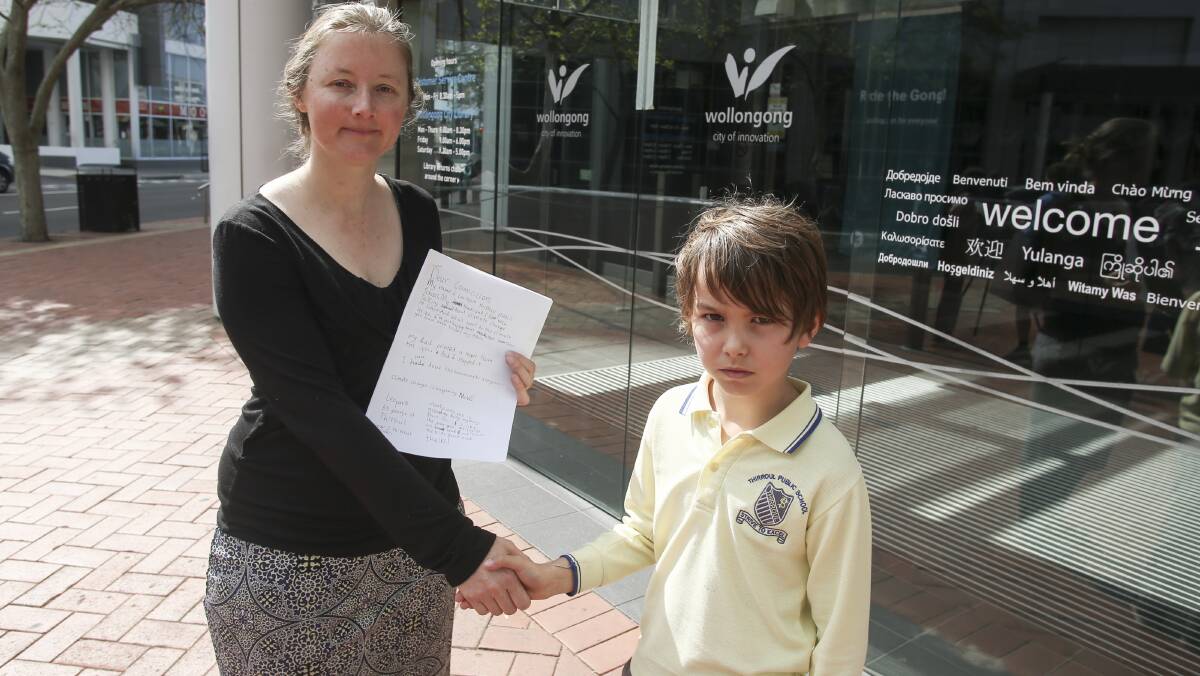 ACTION: Leo Park, 9, of Thirroul Public School presenting his letter about climate change action to Wollongong councillor Cath Blakey. Picture: Anna Warr