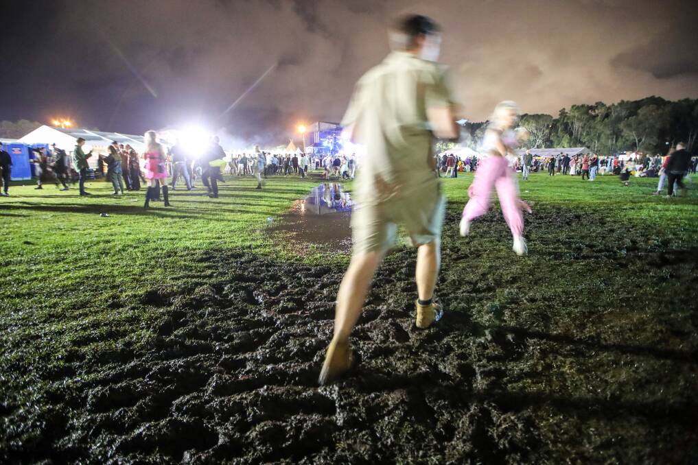 Festival goers navigate the bog. 