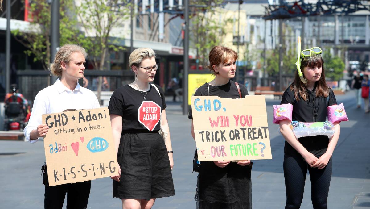 SPOOKY: Australian Youth Climate Coalition members dressed in Halloween gear protesting in Wollongong against engineering firm GHD for its involvement with Adani . Picture: Sylvia Liber.