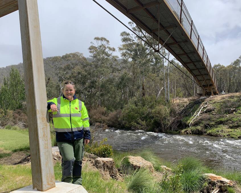 National Parks and Wildlife Service project officer Janelle Herlihy underneath the new 85-metre-long bridge which spans the Thredbo River near the Gaden Trout Hatchery. Picture: Tim the Yowie Man