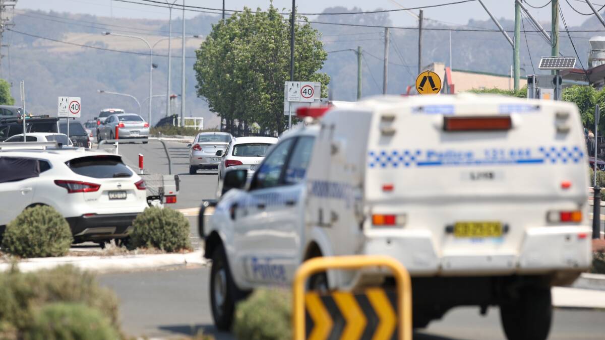 Police arrive at the roundabout on Central Avenue and Fisher Street, Oak Flats, where a man believed to be in his 80s died after being hit by a car on Thursday morning. Picture: Adam McLean.
