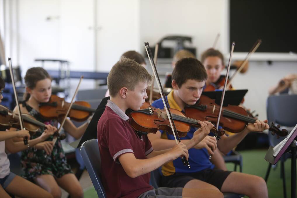 The violin section from the young Llewellyn Strings orchestra, conducted by Sefora Cohut, playing William Tell.