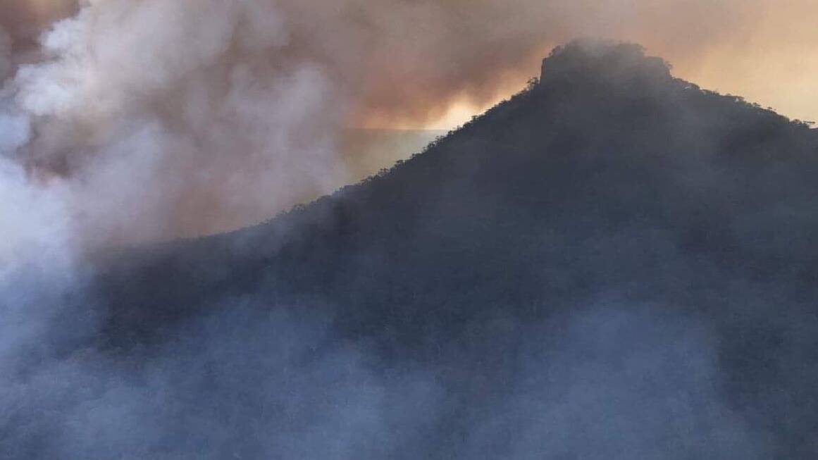 Residents and motorists around Milton may notice active fire approaching the iconic Pigeon House Mountain, the NSW RFS Shoalhaven division said on Sunday. Picture: NSW RFS Shoalhaven Facebook
