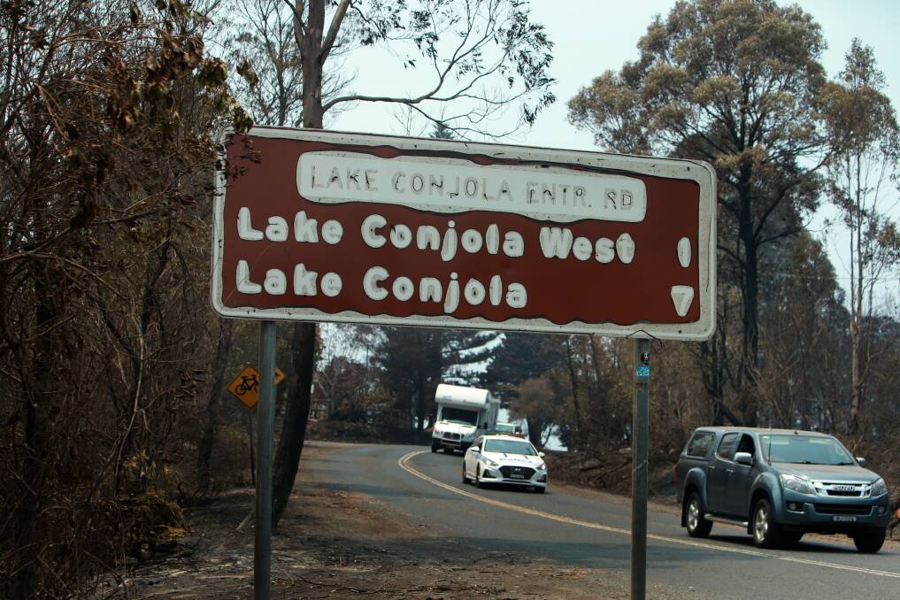 Melted: One of the many fire-damaged road signs in the South Coast. Picture: Sylvia Liber.