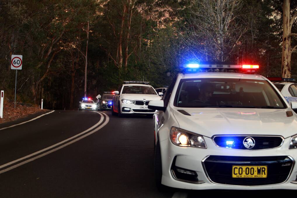 Police at Tapitallee near the Shoalhaven River over the weekend. A strike force has been set up to investigate the cause of the fires on the South Coast. Picture: Sylvia Liber.
