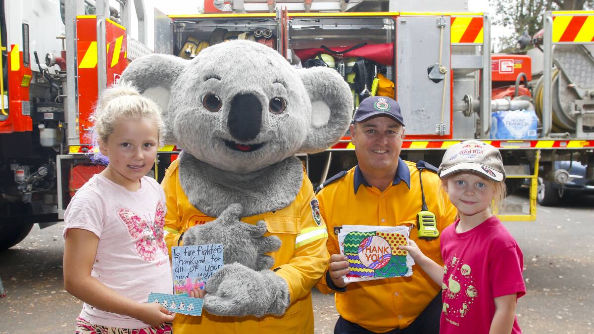 THANK YOU: Heidi Morris, Smokey the Bear, Dapto RFS Captain Bill Reid and Drew Lesley at the special barbecue event at Lindsay Park Public School. Pictures: Anna Warr