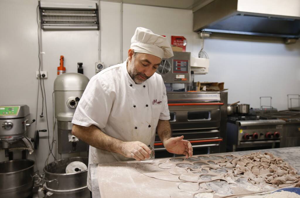 Pasticceria Massimo Papa owner Massimo Papa making cannoli. 