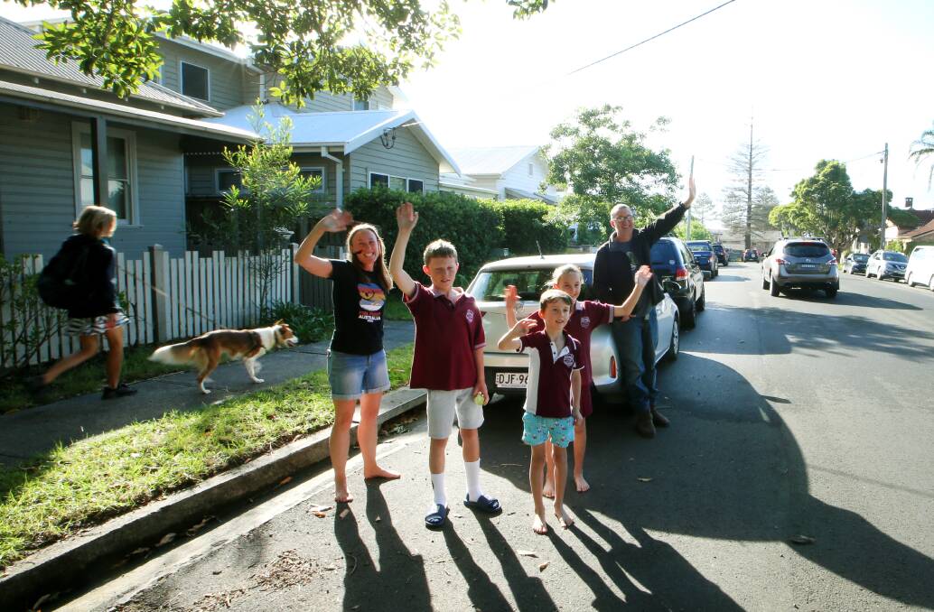 CHEERING: In Austinmer Emma and Troy Heffernan, and their kids Zac, Joey and Grace, came out to greet the school staff. Pictures: Sylvia Liber