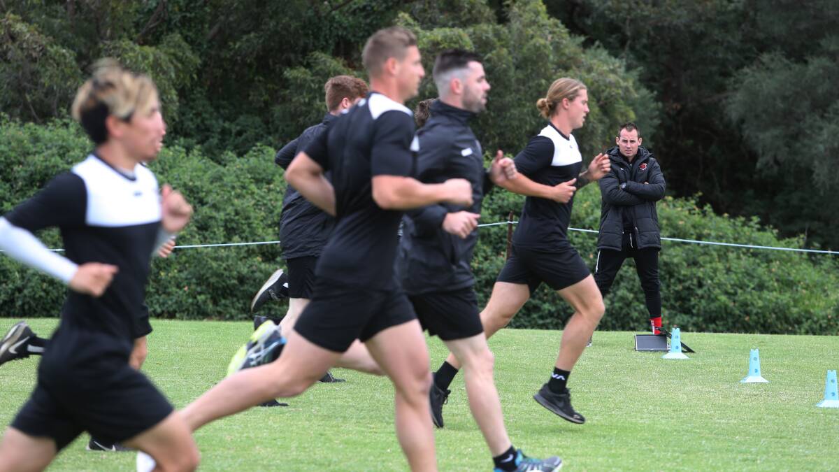 Hit the ground running: Wolves coach Luke Wilkshire watches on as he puts his players through their first training session back on Saturday. Picture: Robert Peet.