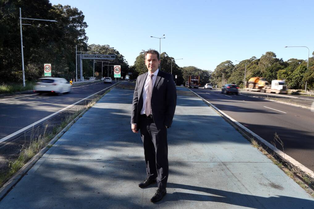 Keira MP Ryan Park at the site of the planned Mt Ousley interchange - he is calling for further funding to be included in the next state budget. Picture: Robert Peet