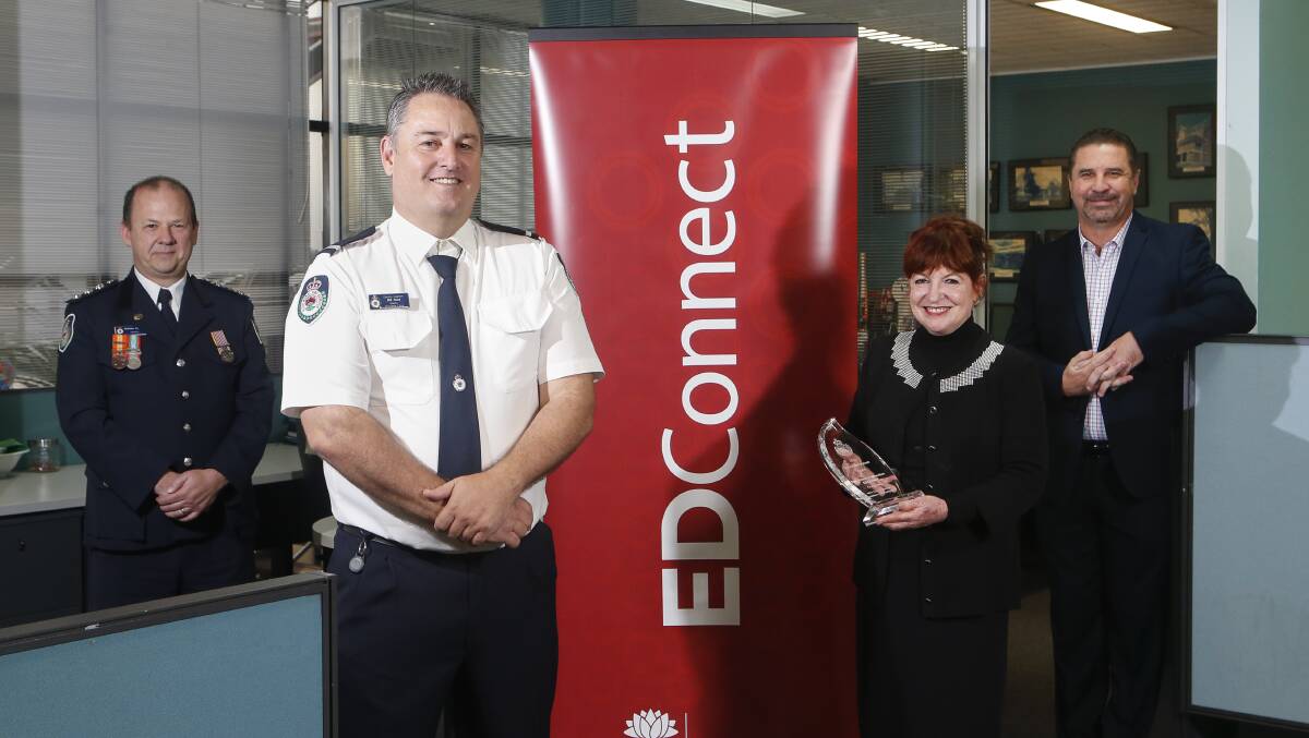 AWARD: NSW RFS district coordinator Matt Reeves, Dapto RFS deputy captain Bill Reid and his EDConnect colleagues Kate Sheehan and Scott Dries. Picture: Anna Warr