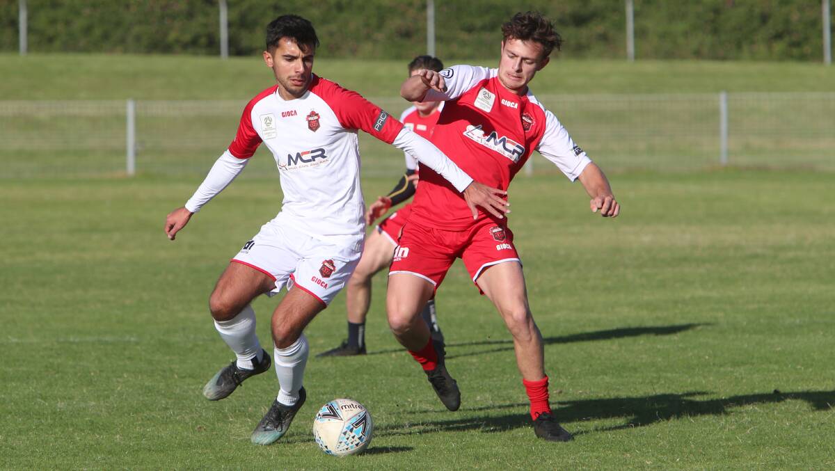 Tough contest: Harry Callahan (right) fights for possession in the Wollongong Wolves internal friendly on Saturday. Picture: Sylvia Liber.