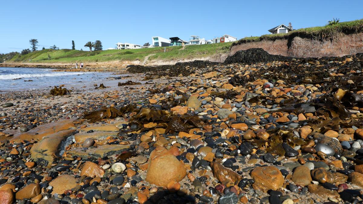 Rocks and seaweed washed up at McCauley's beach in Bulli after an east coast low. Picture: Adam McLean.