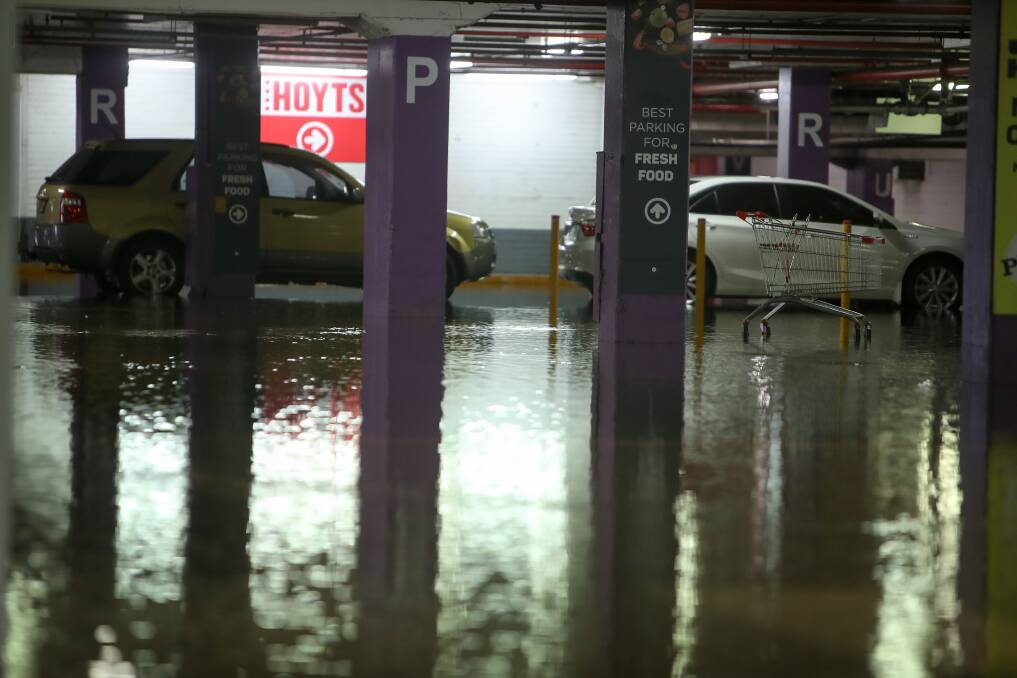 Wet: Shoppers at Warrawong Plaza had to deal with wet feet after the underground car park flooded on Saturday. Picture: Adam McLean