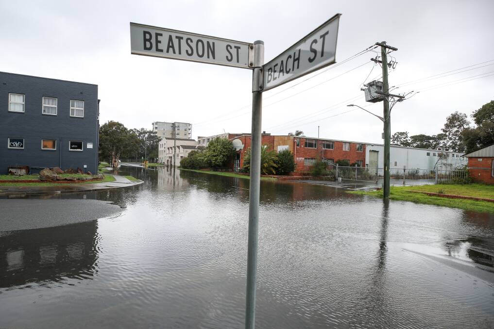 Sign: Water pools at the intersection of Beatson and Beach streets in Wollongong. Picture: Adam McLean