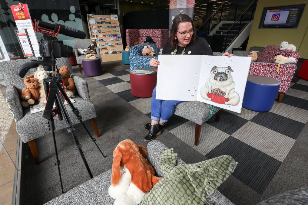 GOING DIGITAL: Wollongong librarian Lisa Beverstock reading Pig the Pug for a recording of the Tiny Bites online storytime. Picture: Adam McLean.