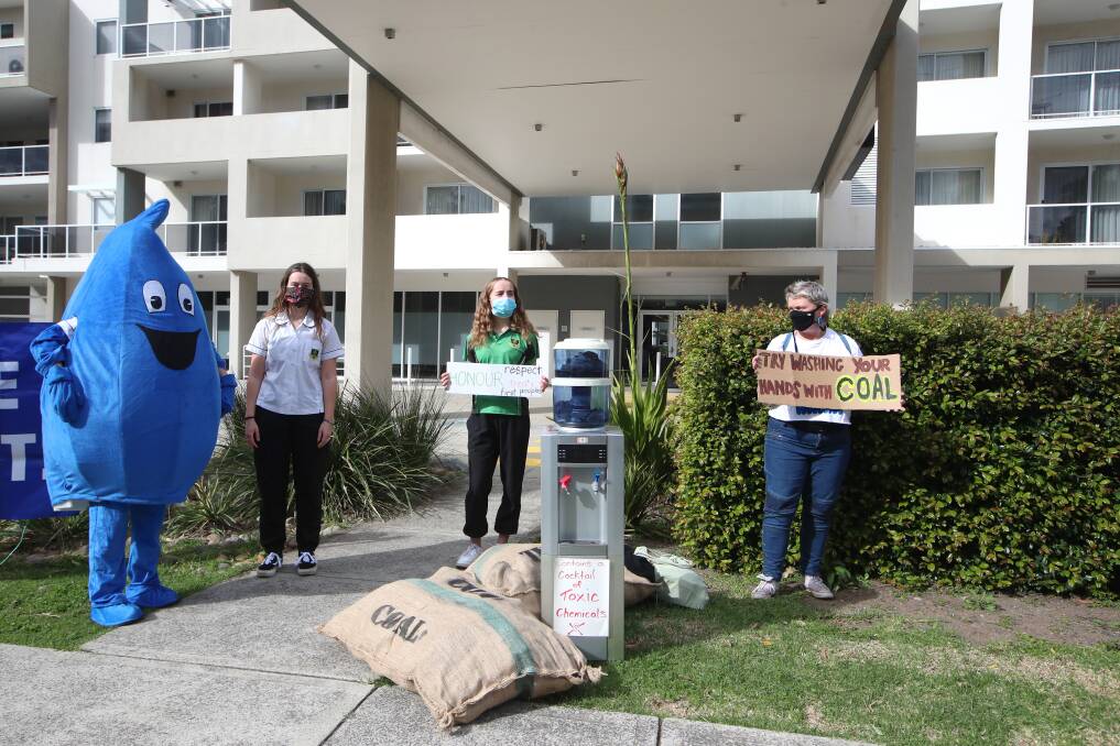 GOOD DROP: Protesters outside Tuesday's Wollongong Coal annual general meeting in Towradgi, while inside the conference room the miner won approval to delist from the ASX. Picture: Sylvia Liber.