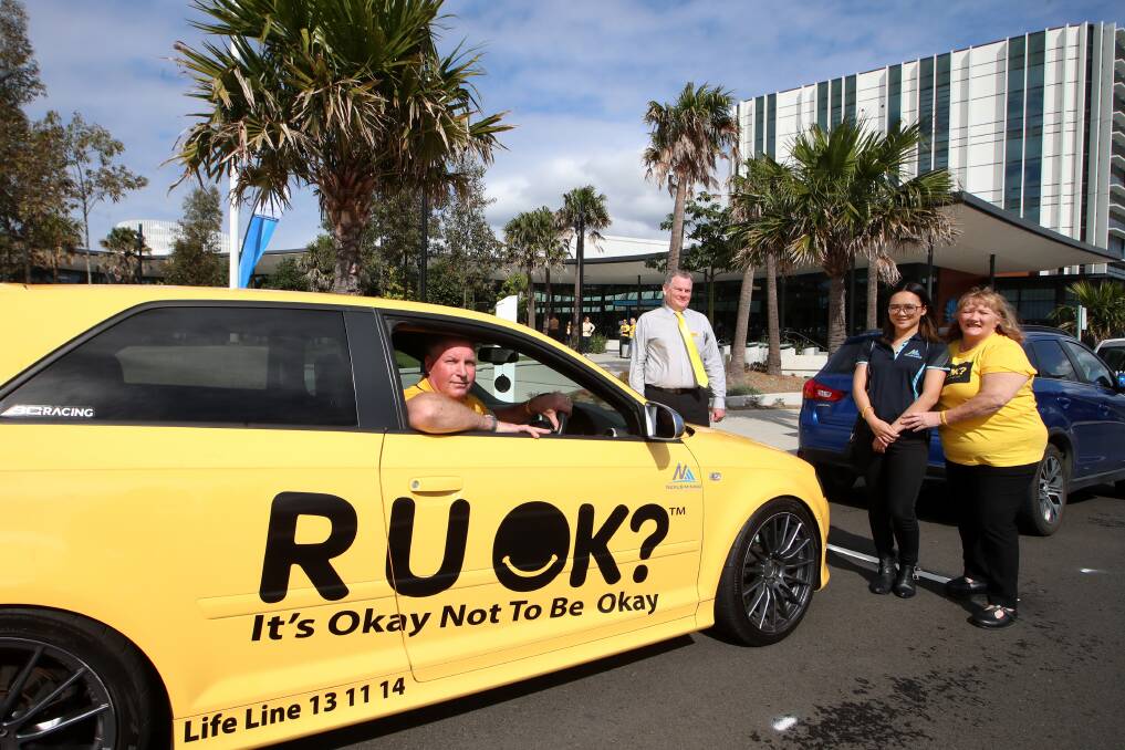 R U OK? DAY: Shellharbour Mayor Marianne Saliba with her daughter Sara, Shellharbour council CEO Carey McIntyre and Hennie Kliengeld in his yellow car. Picture: Sylvia Liber