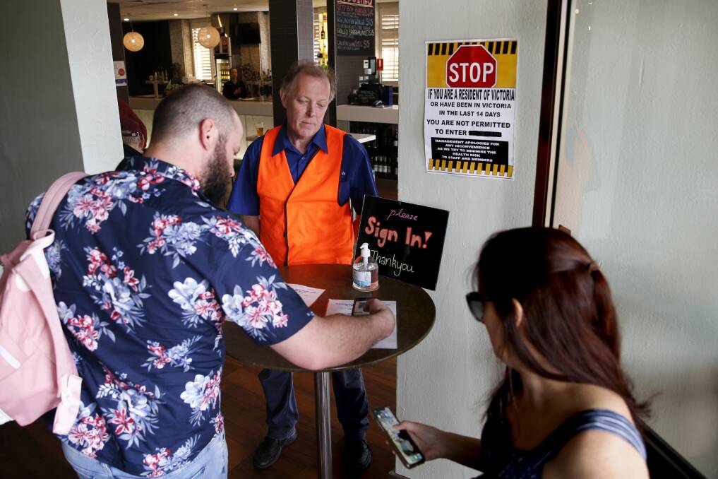 Licencee of the Kiama Inn Hotel, Lionel Boekenstein, working as a COVID-marshall at the venue on Sunday, ensuring people correctly sign in. Picture: Anna Warr